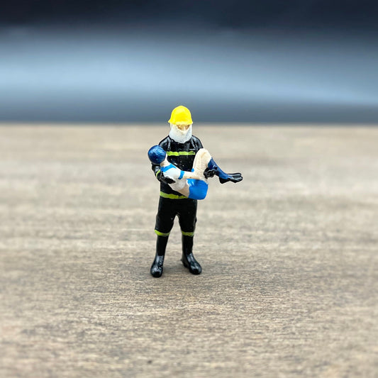 Fireman Saving Girl. Miniature Human Figure. 1:64 Scale