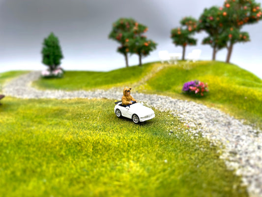 Miniature Boy in Electric Toy Car. 1:64 Scale Human Figure